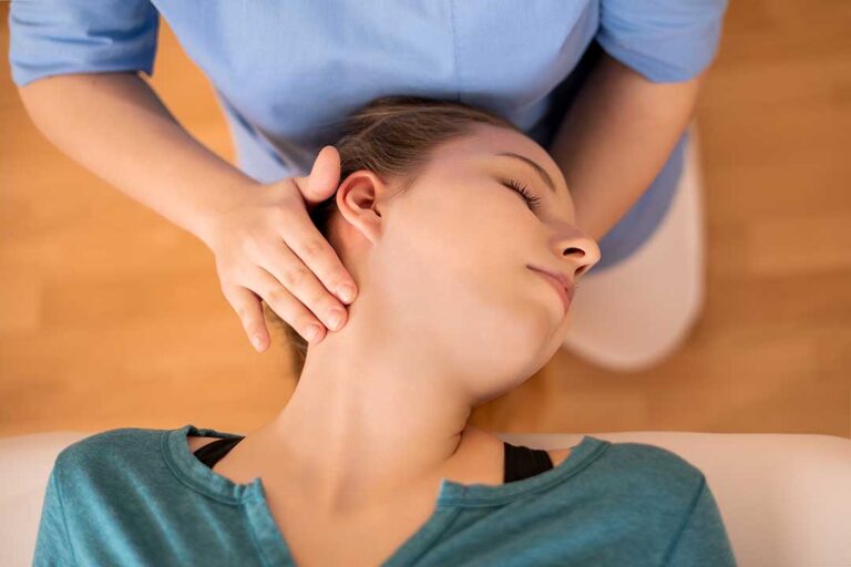 Person receiving a spinal adjustment from a chiropractor in a comfortable, well-lit treatment room.